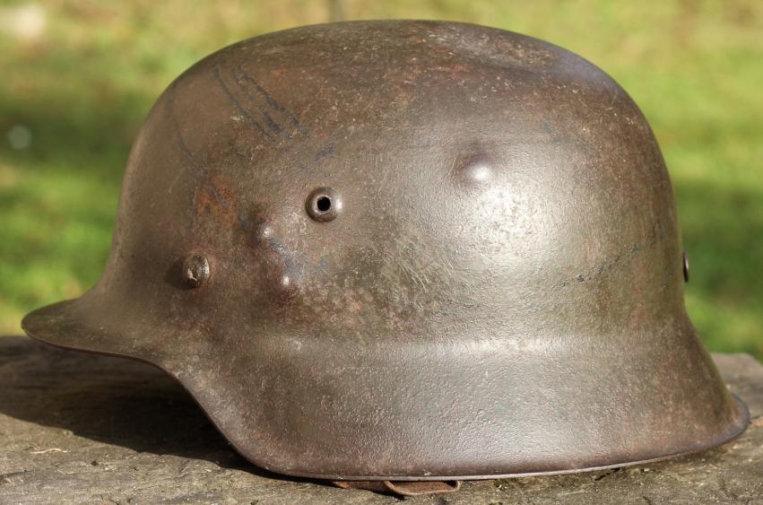 BATTLE DAMAGED M42 COMBAT HELMET